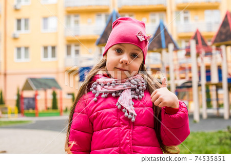 Girl portrait with thumb up at outdoor playground Girl portrait with thumb up at outdoor playground 74535851