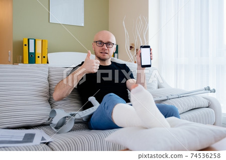 A contented man with a broken leg in a cast. He received insurance compensation. 74536258