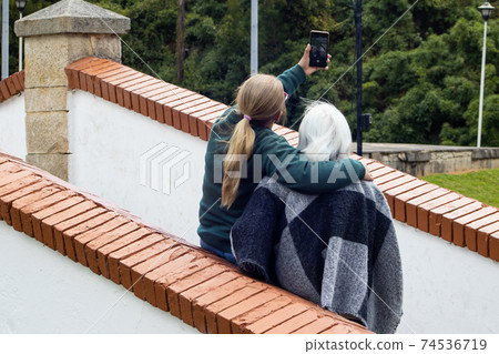 Senior mother and adult daughter traveling. The famous historic Bridge of Boyaca in Colombia. The Colombian independence Battle of Boyaca took place here on August 7, 1819. Senior mother and adult daughter traveling. The famous historic Bridge of Boyaca in Colombia. The Colombian independence Battle of Boyaca took place here on August 7, 1819. 74536719
