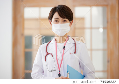 Female doctor wearing a mask 74536882