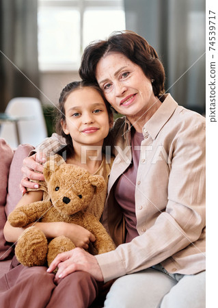 Affectionate mature brunette woman and her adorable little granddaughter Affectionate mature brunette woman and her adorable little granddaughter 74539717