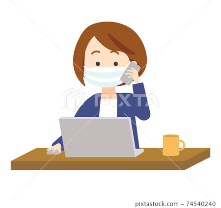 A woman in a mask who operates a computer while making a phone call with a smartphone A woman in a mask who operates a computer while making a phone call with a smartphone 74540240