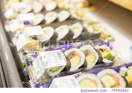 Thick sushi rolls lined up in supermarkets 74540482