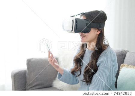 A woman enjoying VR in the living room A woman enjoying VR in the living room 74542933