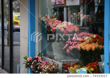 Yellow taxi reflected in the window of the flower shop Yellow taxi reflected in the window of the flower shop 74543017
