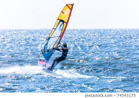 Windsurfing running in the wind Windsurfing running in the wind 74543173