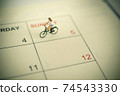 Girl riding bicycle with vintage weekend calendar 74543330