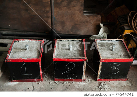 Steel bolt in concrete block for strength testing Steel bolt in concrete block for strength testing 74544741