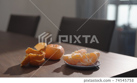 tangerine on walnut wood table indoor 74545758