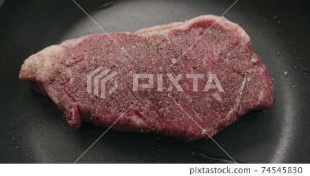 new york steak on nonstick pan 74545830