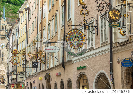 Salzburg, Austria - May 19,2019 : city skyline and wrought iron signs at Grain Lane street the famous shopping street of Salzburg Austria 74546226