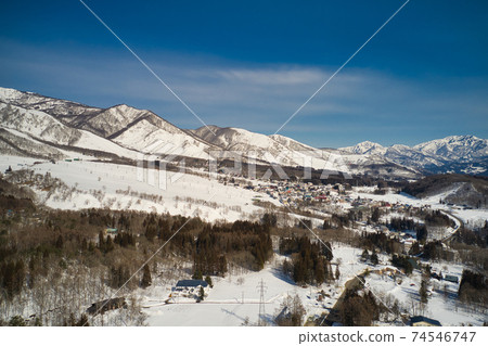 Tsugaike Kogen / Hakuba Norikura Ski Resort seen from Ochikura, Hakuba Village, Nagano Prefecture (aerial view by drone) 74546747