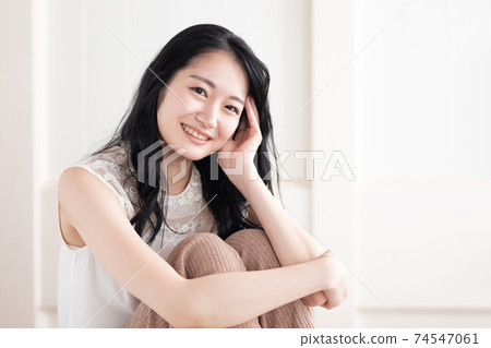 A woman sitting in a room A woman sitting in a room 74547061