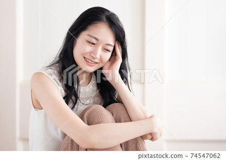 A woman sitting in a room A woman sitting in a room 74547062