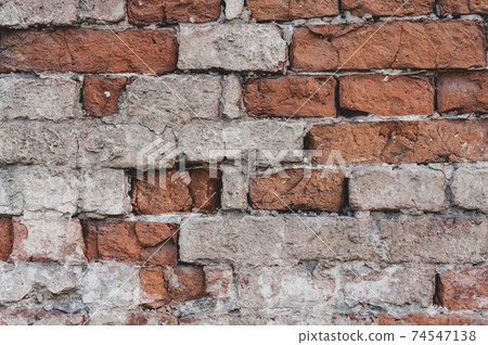 Background old surface, vintage wall with red bricks with peeling plaster, grungy texture. 74547138