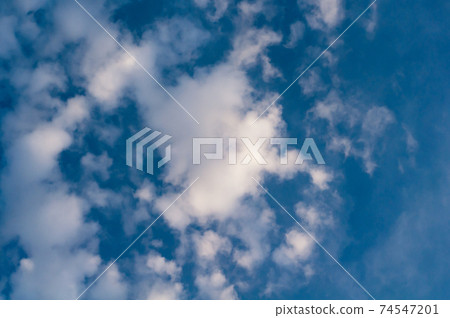 White translucent cloud against blue sky. Outdoors. White translucent cloud against blue sky. Outdoors. 74547201
