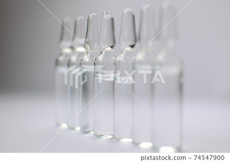 Medical ampoules for injection isolated on white background. Medicines and disease treatment, pharmacology and science concepts 74547900