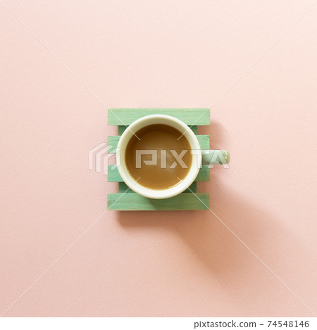 Green cup of coffee on pink background. top view, copy space Green cup of coffee on pink background. top view, copy space 74548146