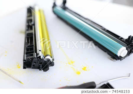 Yellow and blue cartridges for printer lying on table closeup Yellow and blue cartridges for printer lying on table closeup 74548153