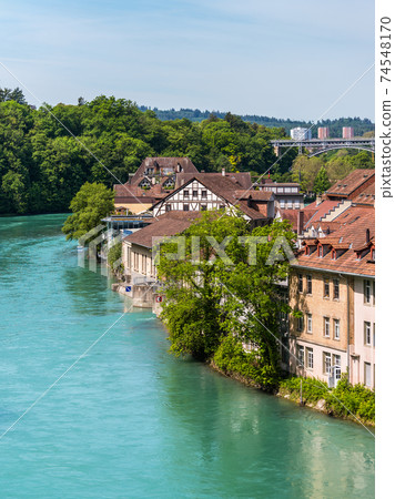 Medieval houses lining the banks of the Aare river in Bern, Switzerland 74548170
