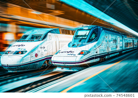 Modern hi-speed passenger train of Spanish Railways Company - Renfe, in  movement (motion). 74548601