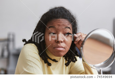 Real African American Woman Doing Make Up 74549694