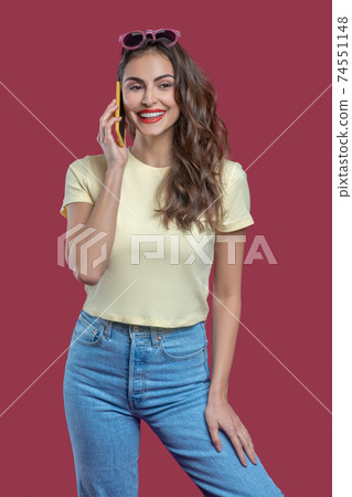 Beautiful woman in casual clothes talking on smartphone 74551148