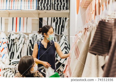 Elderly woman in wheelchair with daughter doing shopping in shopping store. Elderly woman in wheelchair with daughter doing shopping in shopping store. 74551936
