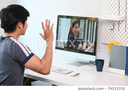Businessman talking with his colleagues in video conference online on computer during work from home. Businessman talking with his colleagues in video conference online on computer during work from home. 74552358