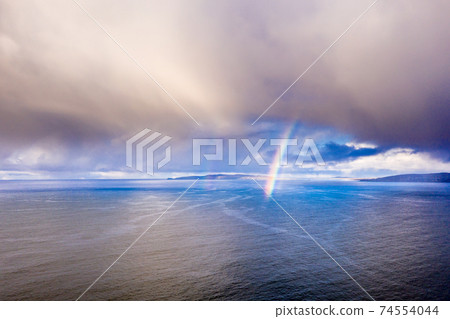 Aerial view of an rainbow above the Atlantic Ocean in Donegal - Ireland Aerial view of an rainbow above the Atlantic Ocean in Donegal - Ireland 74554044