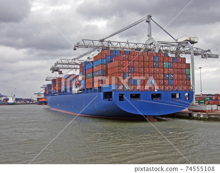 Large container cargo ship at the port in Rotterdam 74555108