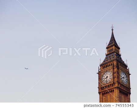 Big Ben dial and airplane against the backdrop of the pale sky of London, England 1 Big Ben dial and airplane against the backdrop of the pale sky of London, England 1 74555343