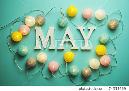 May alphabet letter with cotton ball LED decoration on blue background May alphabet letter with cotton ball LED decoration on blue background 74555669