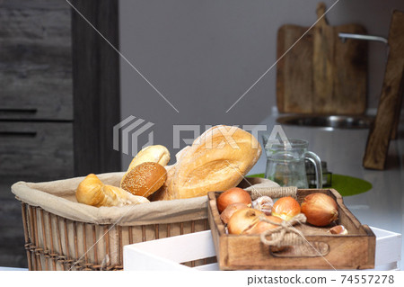 muffin lies in the kitchen in a small basket, loaves, bread and rolls. Bad food, fullness, copy space 74557278
