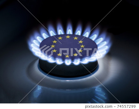 Burning gas burner of a home stove in the middle of which is the flag of the country of European Union. Gas import and export delivery concept, price per cubic meter, transit, background 74557299