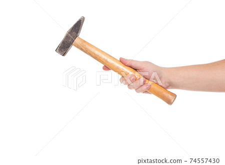 Man holds a hammer in his hand on a white background, isolate. Close-up Man holds a hammer in his hand on a white background, isolate. Close-up 74557430