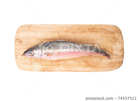 Red-eyed sea fish on a wooden kitchen board on a white background, isolate. reshness Red-eyed sea fish on a wooden kitchen board on a white background, isolate. reshness 74557521