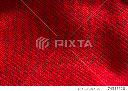 Red knitted sweater close-up. Material background, macro Red knitted sweater close-up. Material background, macro 74557628