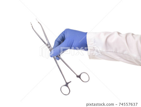 Doctor in a medical glove holds a surgical scissors on a white background, isolate. Close-up Doctor in a medical glove holds a surgical scissors on a white background, isolate. Close-up 74557637