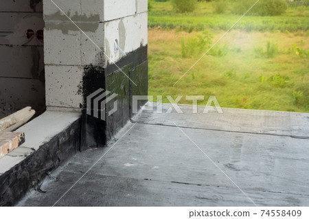 Waterproofing flat roof terrace with bitumen roofing material. Waterproofing flat roof terrace with bitumen roofing material. 74558409
