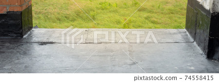 Waterproofing flat roof terrace with bitumen roofing material. 74558415