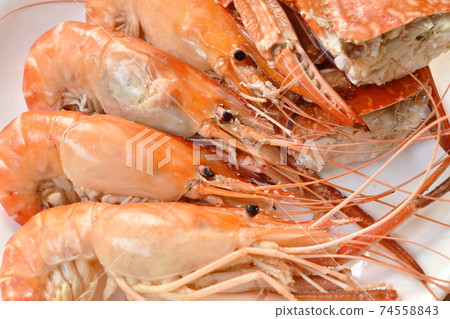 steamed shrimp and cutting flower crab on plate eat with fresh vegetable dipping spicy and sour sauce steamed shrimp and cutting flower crab on plate eat with fresh vegetable dipping spicy and sour sauce 74558843