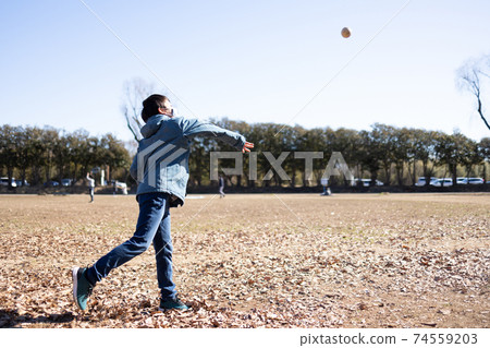 A boy playing a catch ball A boy playing a catch ball 74559203