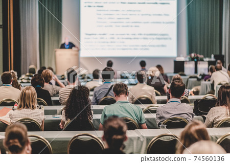 Audience in lecture hall participating at business conference. Audience in lecture hall participating at business conference. 74560136