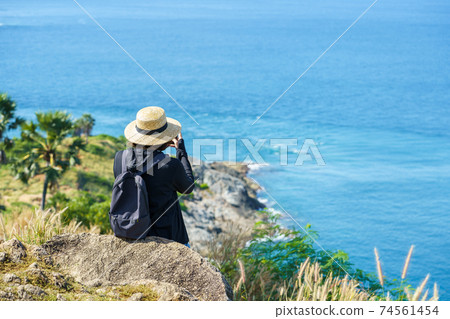 Travelers at Phromthep cape viewpoint at the south of Phuket Island, Thailand. Tropical paradise in Thailand. Phuket is a popular destination famous for tourists 74561454