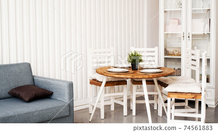 Round wooden dining table and white chairs. Modern Scandinavian interior Round wooden dining table and white chairs. Modern Scandinavian interior 74561883