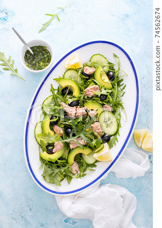 Tuna arugula salad served in an oval dish 74562674