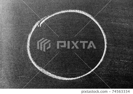 White color chalk hand drawing in circle or oval shape on black board background White color chalk hand drawing in circle or oval shape on black board background 74563334