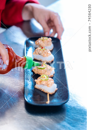 Chef plating finished appetizer Chef plating finished appetizer 74564280