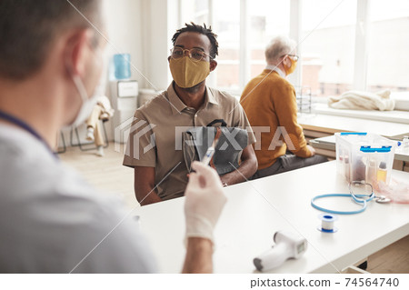 African American Man at Vaccination Center African American Man at Vaccination Center 74564740